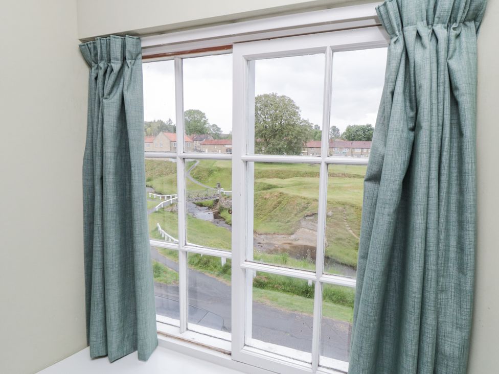 A window with curtains overlooking a landscape at Brookleigh in Hutton-le-Hole
