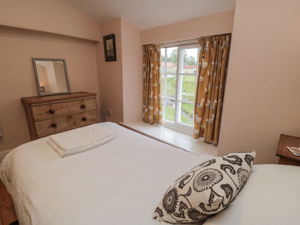 A bedroom with a bed and wooden dresser at Brookleigh in Hutton-le-Hole