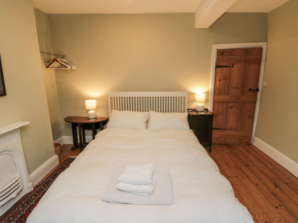 A bedroom with a bed and a lamp at Brookleigh in Hutton-le-Hole