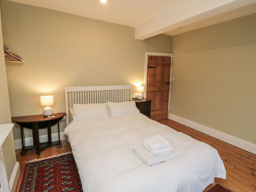 A bedroom with a bed and a nightstand at Brookleigh in Hutton-le-Hole