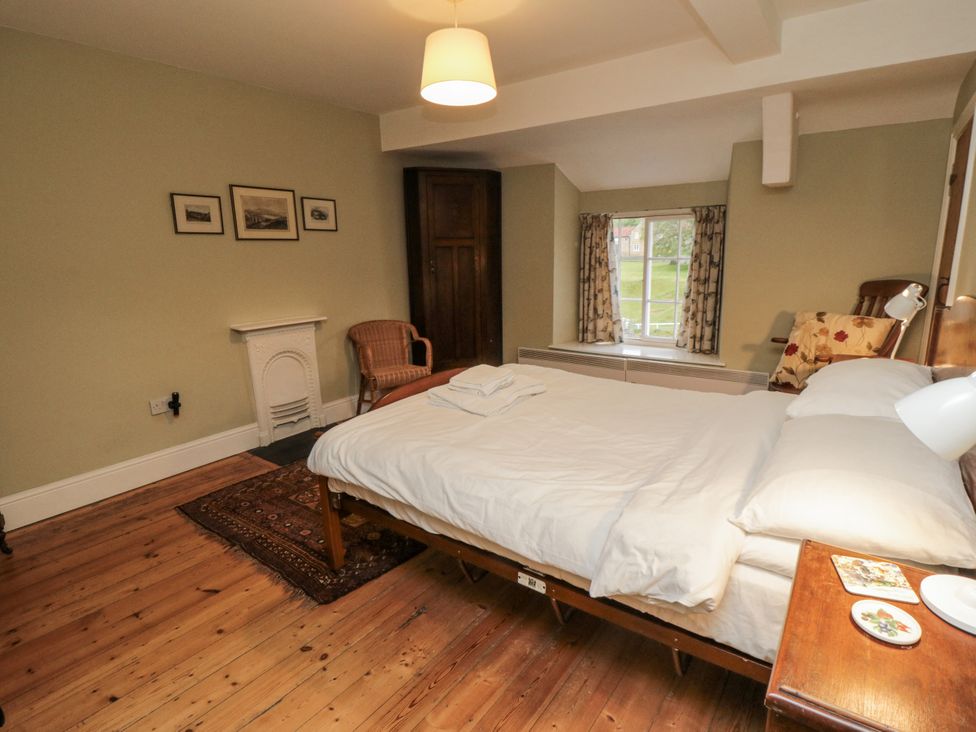 A bedroom with a bed and chair at Brookleigh in Hutton-le-Hole