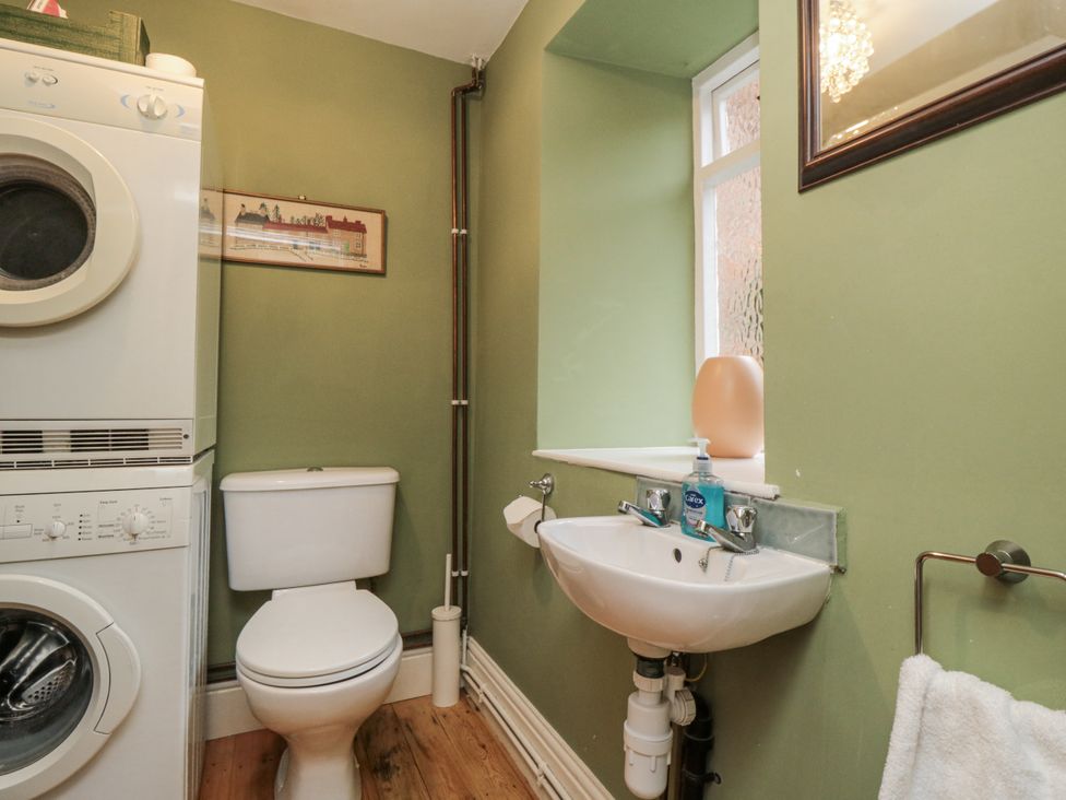 A bathroom with a washing machine and sink at Brookleigh in Hutton-le-Hole