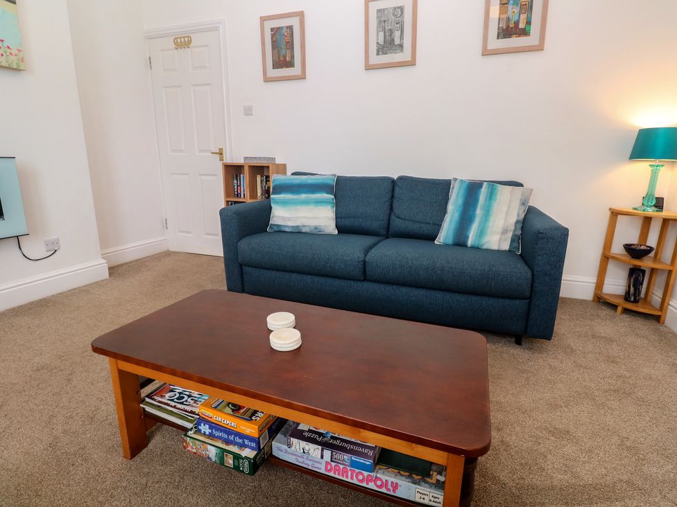 A living room with a sofa and coffee table at Apartment 1 Llewellan in St Ives