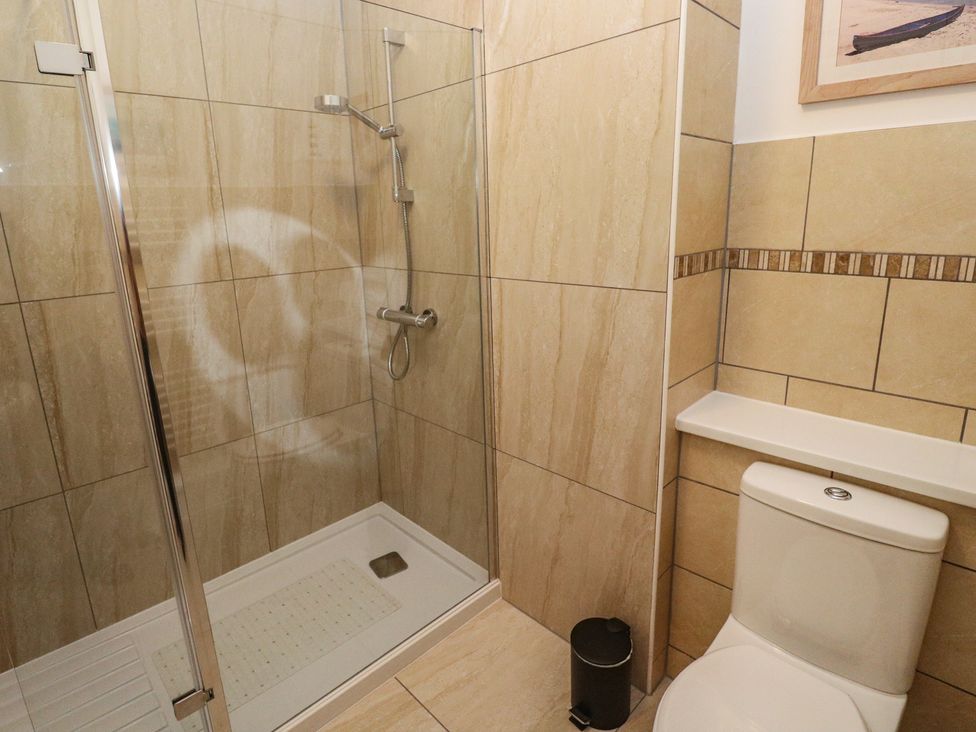 A shower and toilet in a bathroom at Apartment 1 Llewellan in St Ives