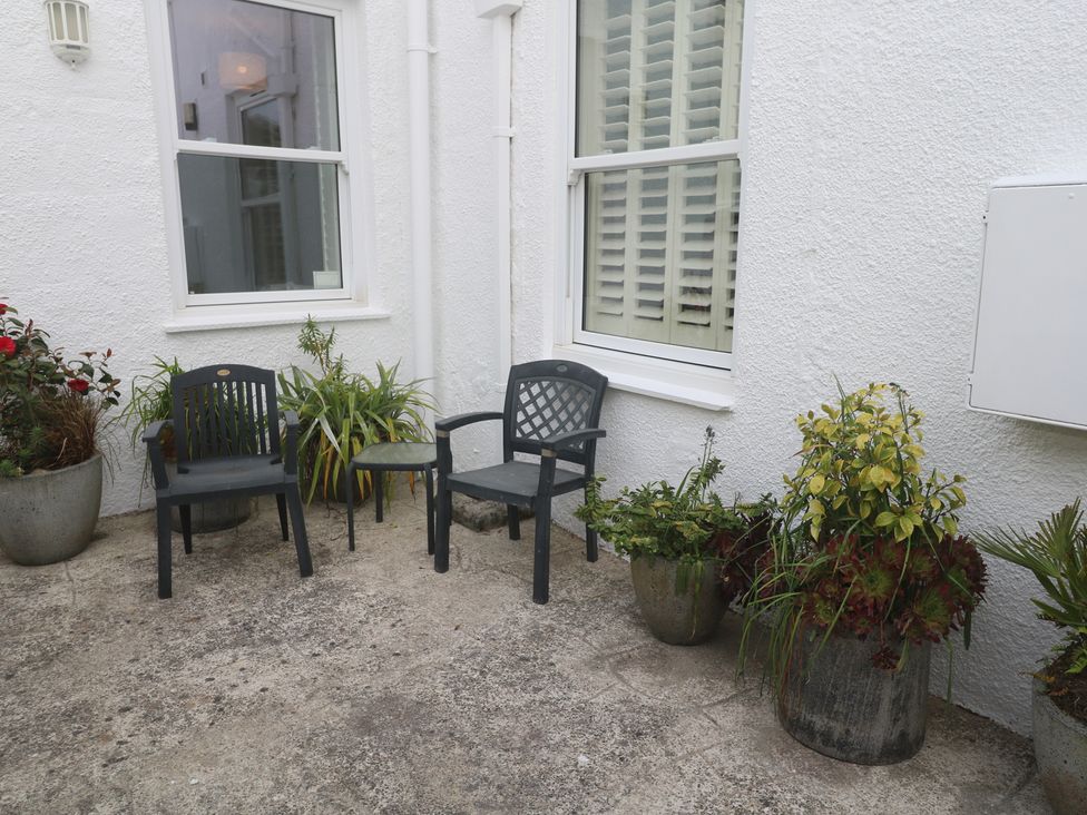 A outdoor area with chairs and planters at Apartment 1 Llewellan in St Ives