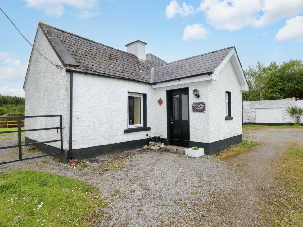 An exterior view of a cottage with a door and window at Ballaghboy Cottage in Boyle, County Sligo