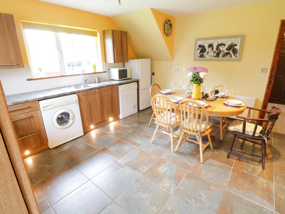 A kitchen with a dining table and chairs at Ballaghboy Cottage in Boyle, County Sligo