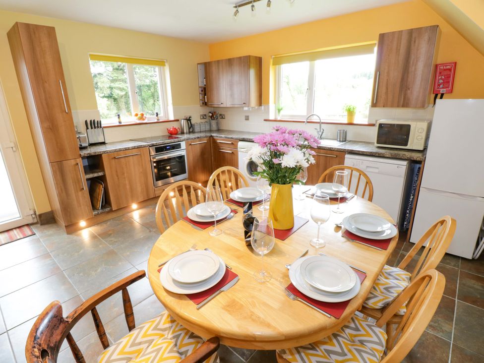 A kitchen with a dining table and chairs at Ballaghboy Cottage in Boyle, County Sligo