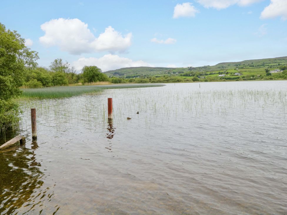 A lake surrounded by trees and hills at Ballaghboy Cottage Boyle, County Sligo