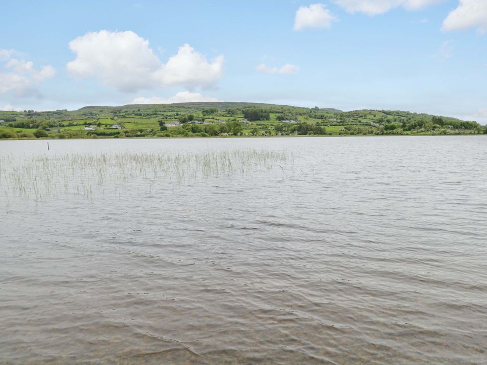A view of a lake and hills with grass at Ballaghboy Cottage in Boyle, County Sligo