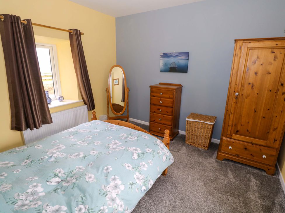 A bedroom with a bed and furniture at Ballaghboy Cottage in Boyle, County Sligo