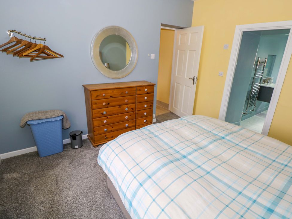 A bedroom with a bed and dresser at Ballaghboy Cottage in Boyle, County Sligo