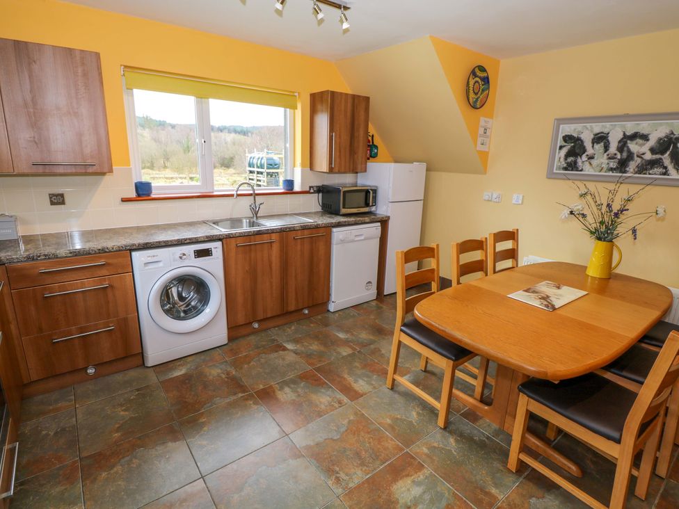 A kitchen with countertop, table and chairs at Ballaghboy Cottage in Boyle, County Sligo