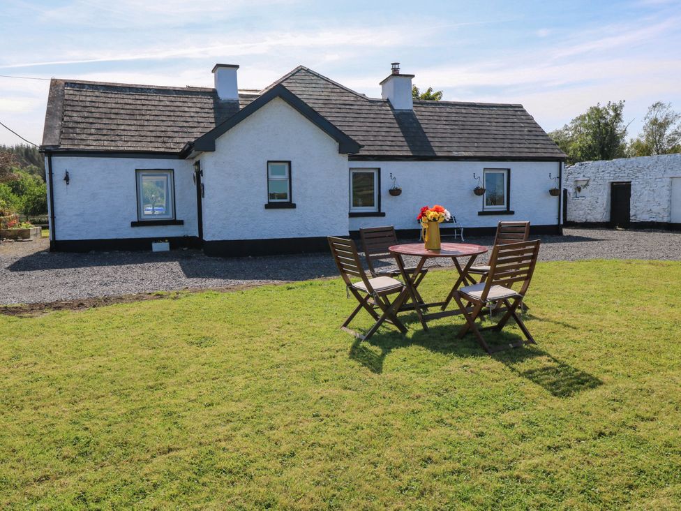 A house with a table and chairs in front at Ballaghboy Cottage, Boyle, County Sligo