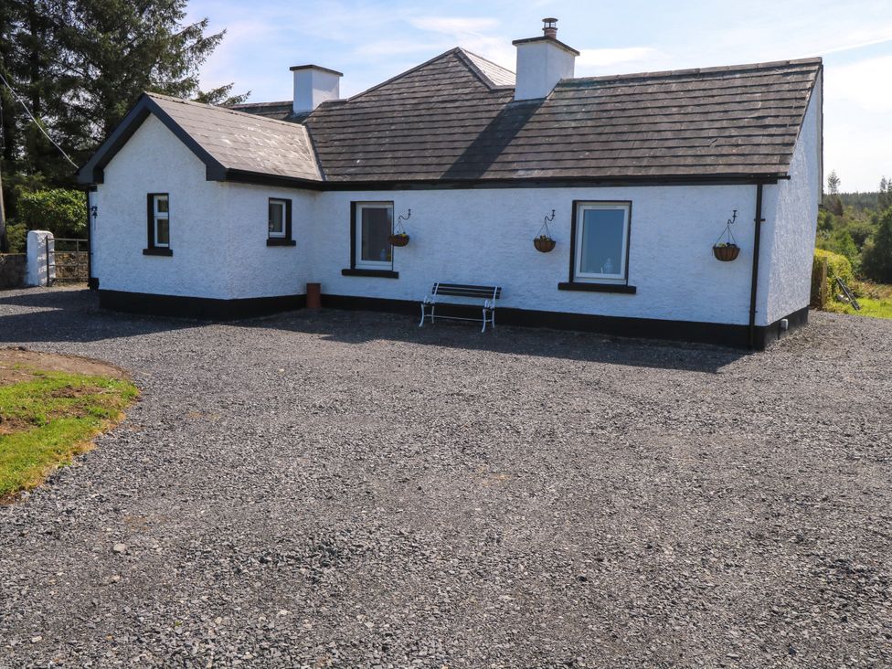 A house with windows and a bench in the outdoor area at Ballaghboy Cottage Boyle, County Sligo