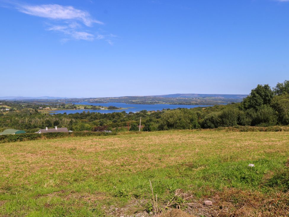 A view of a lake surrounded by trees and hills at Ballaghboy Cottage in Boyle, County Sligo