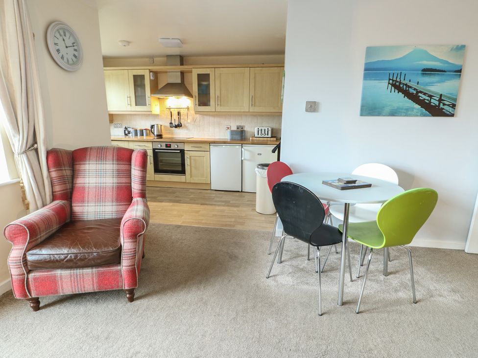 A living room with a kitchen area at Beach View in Benllech near Red Wharf Bay