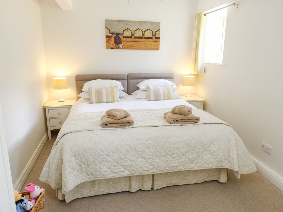 A bedroom with a bed and bedside tables at Bullace Barn in Millhouse Green