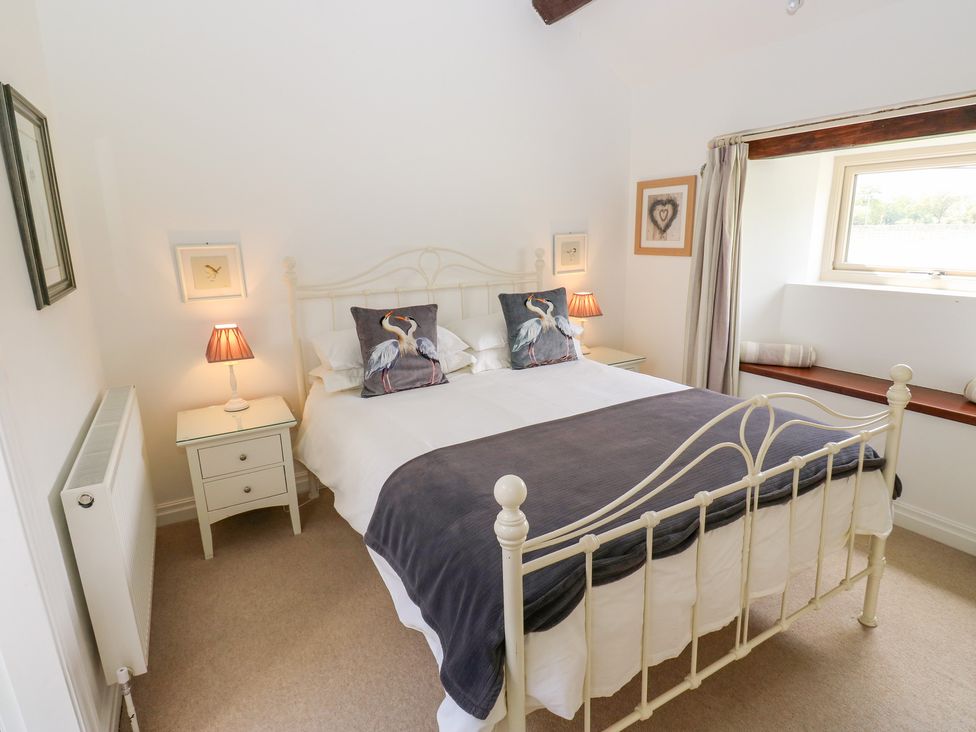 A bedroom with a bed and bedside table at Bullace Barn in Millhouse Green