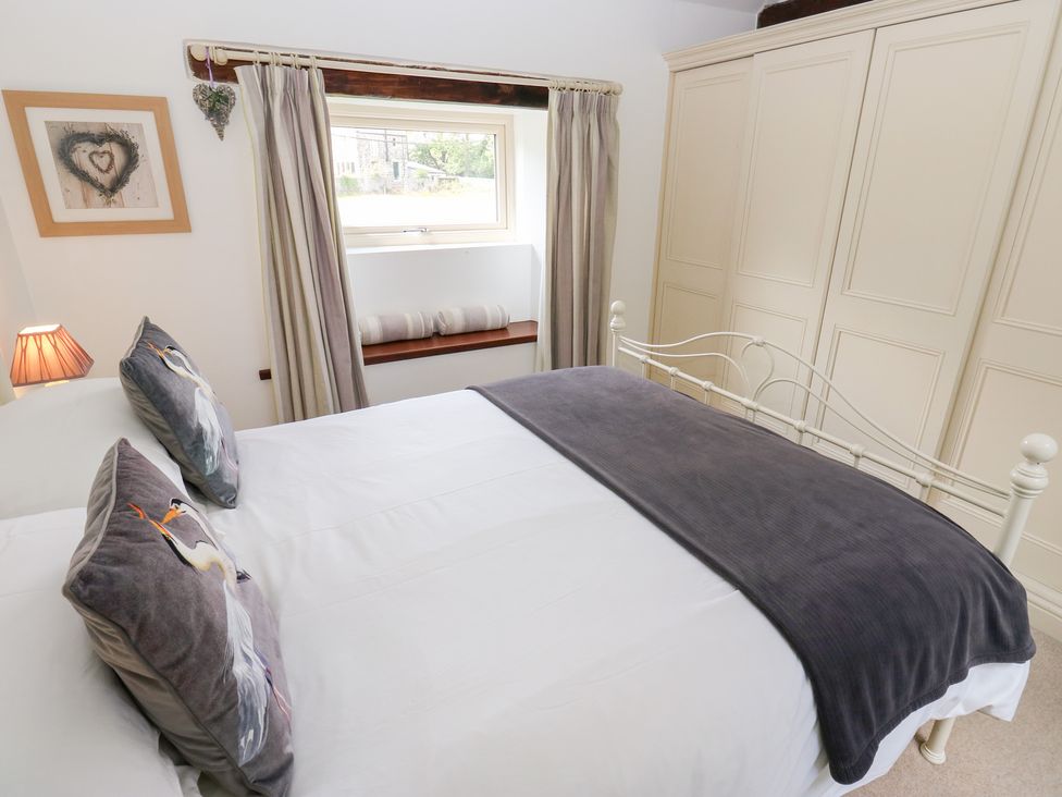 A bedroom with a bed and wardrobe at Bullace Barn Millhouse Green