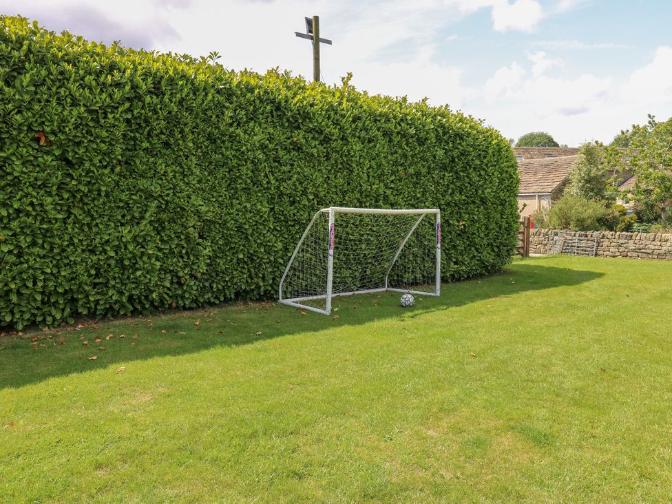 A garden area with a goal post and a soccer ball at Bullace Barn in Millhouse Green