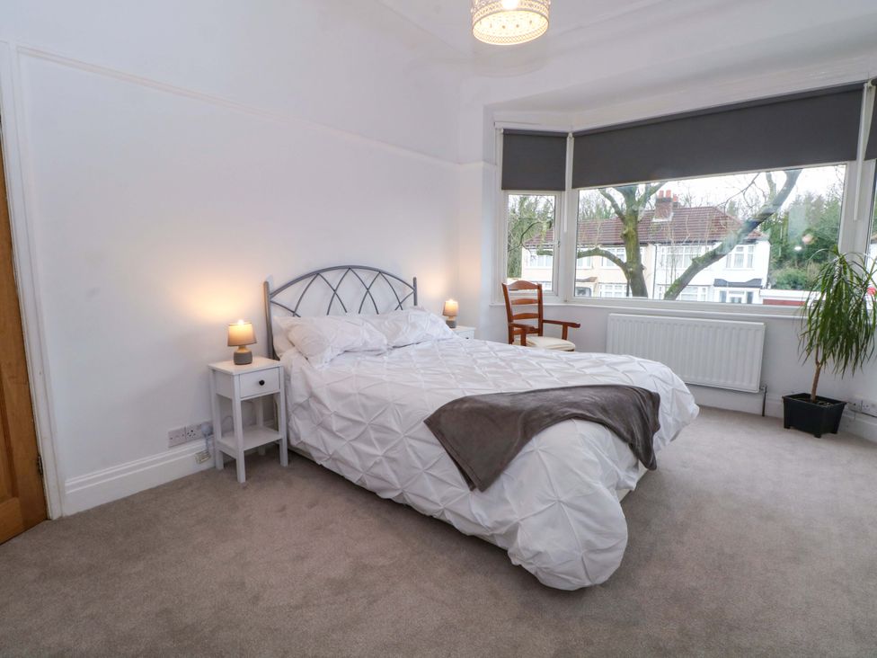 A bedroom with a bed and a chair at Thomas Lane Liverpool