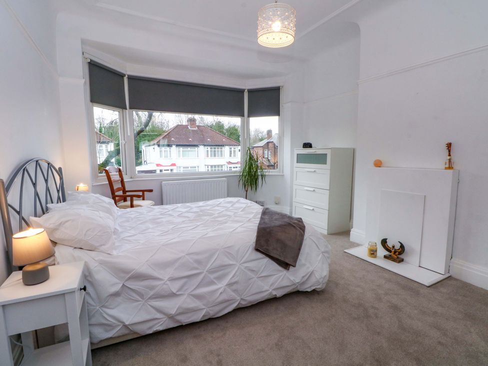 A bedroom with a bed and a dresser at Thomas Lane in Liverpool