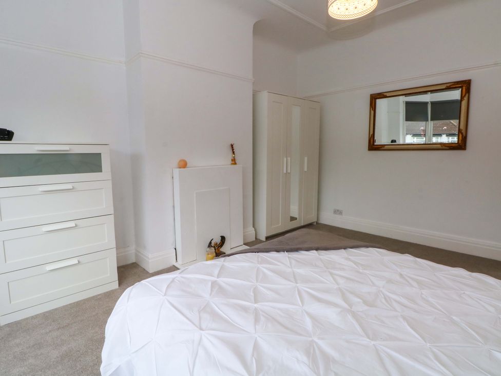 A bedroom with a bed and dresser at Thomas Lane Liverpool