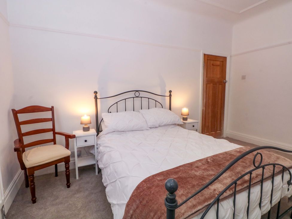 A bedroom with a bed and a chair at Thomas Lane in Liverpool