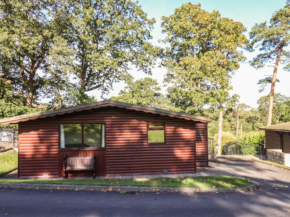 A cabin with windows and a bench at Bluebell Lodge Saltburn-by-the-Sea