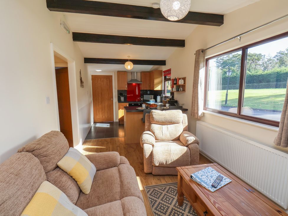 A living room with a sofa and armchair at Bluebell Lodge Saltburn-by-the-Sea