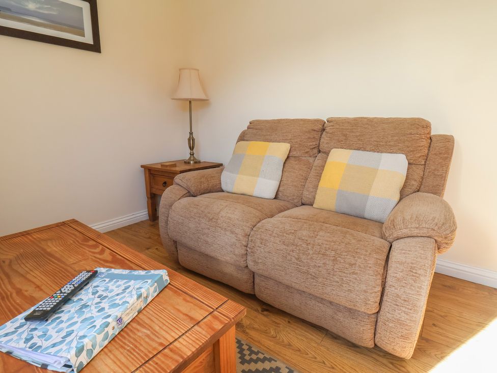 A living room with a sofa and side table at Bluebell Lodge Saltburn-by-the-Sea