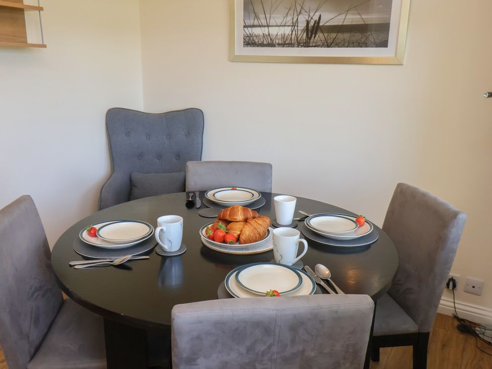 A dining room with a set table at Bluebell Lodge in Saltburn-by-the-Sea