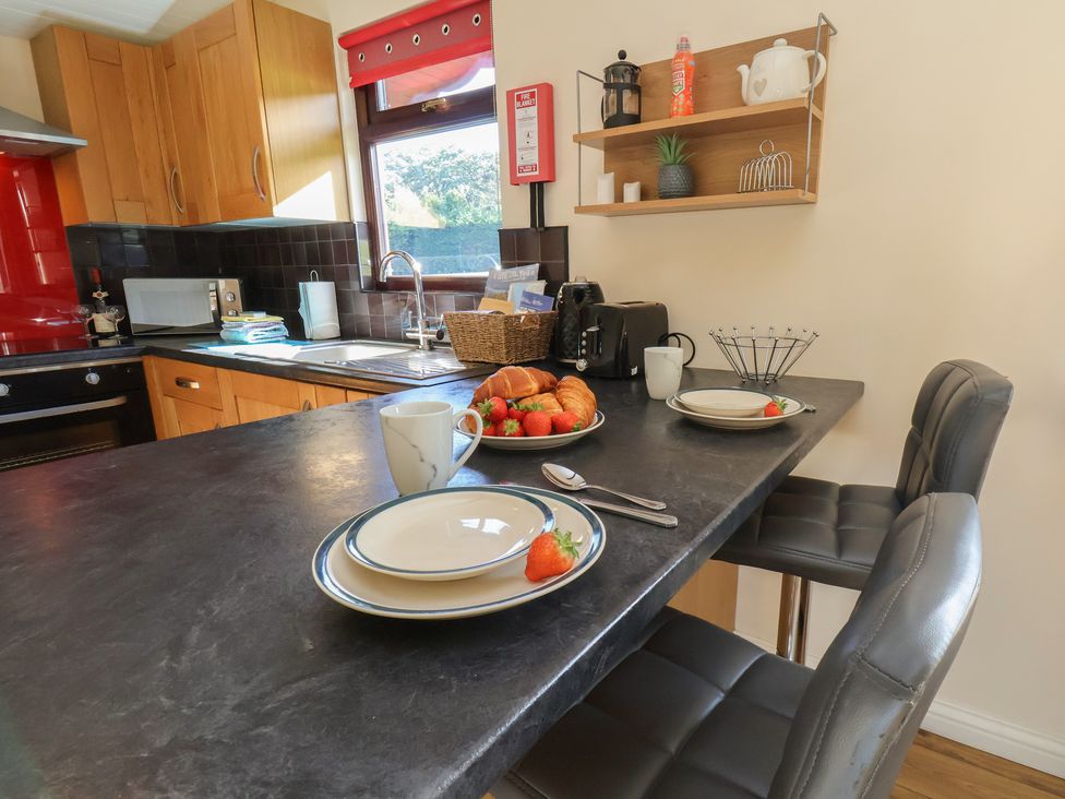 A kitchen with a dining area and table setting at Bluebell Lodge Saltburn-by-the-Sea