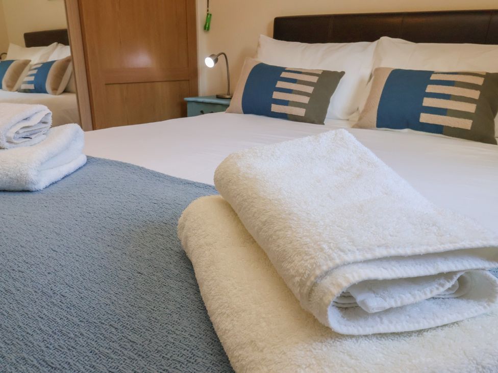A bedroom with a bed and towels at Bluebell Lodge Saltburn-by-the-Sea