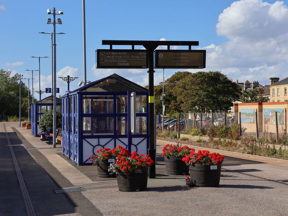 A bus stop with flower pots and an information board at Bluebell Lodge Saltburn-by-the-Sea