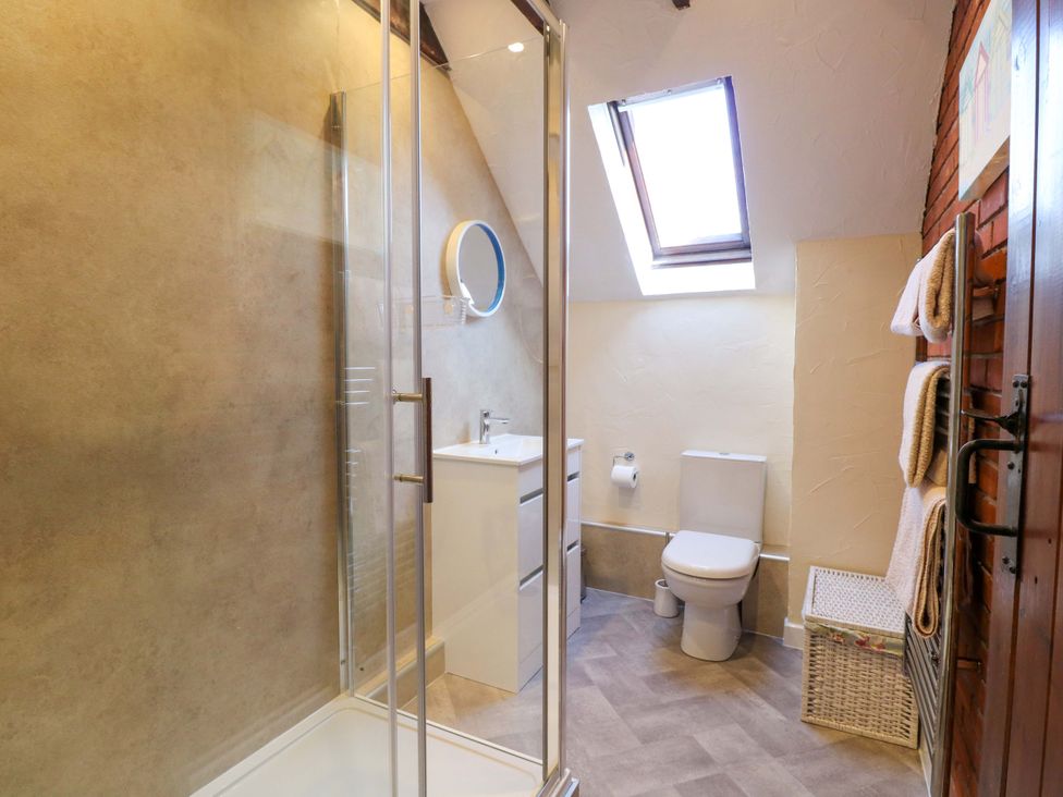 A bathroom with a shower, toilet, and sink at Sweet Briar Barn, Coltishall, Norfolk Broads