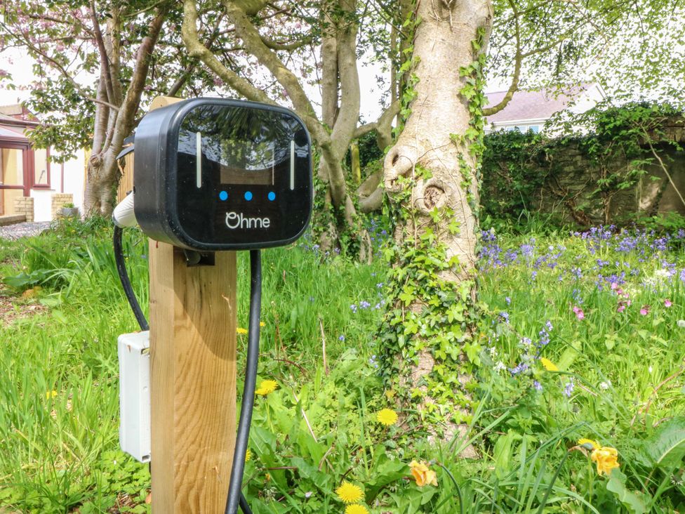 An electric vehicle charger installed in a garden at Ty Taid Llanddaniel Fab near Beaumaris