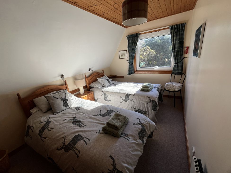 A bedroom with two beds and a window at Suil Na Mara Aultbea