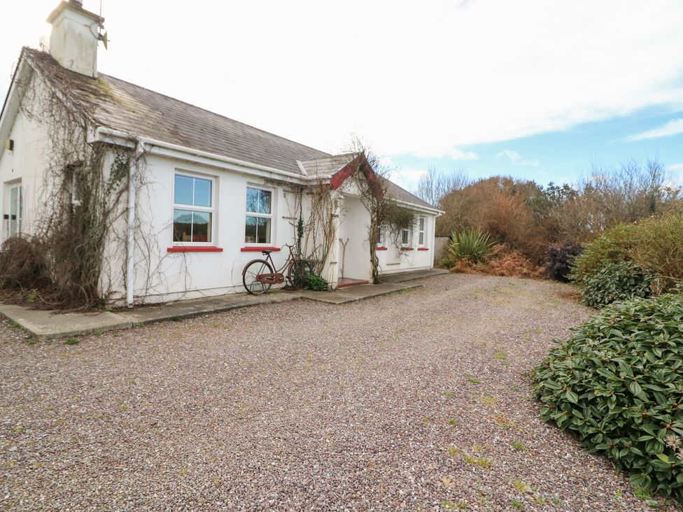 A house with a bicycle in front at Herons Cove Cottage Ballydehop