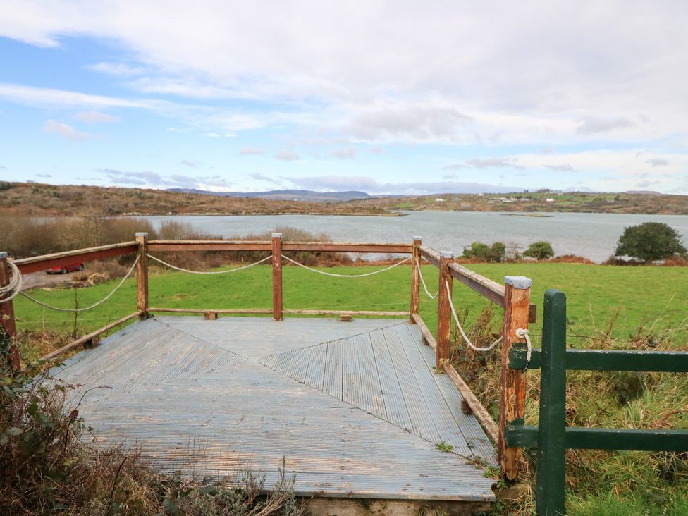 A deck area overlooking water at Herons Cove Cottage Ballydehop