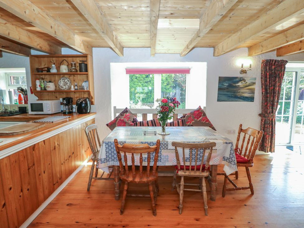 A dining room with a table and chairs at Fuschia Cottage in Waterville, County Kerry