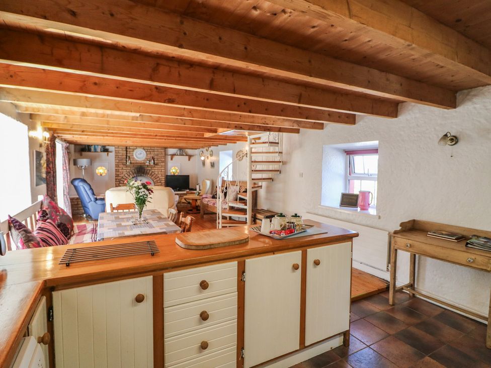 A kitchen with an open layout and dining area at Fuschia Cottage in Waterville, County Kerry