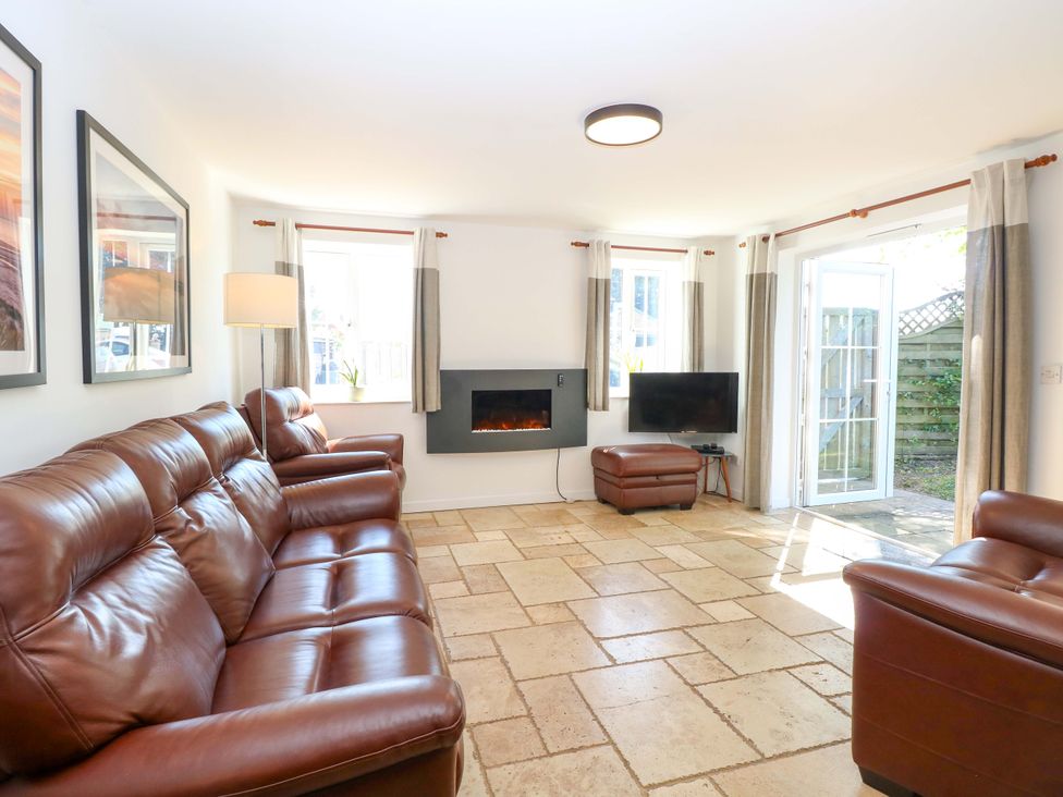 A living room with a sofa and television at Mill Lodge in Brisley