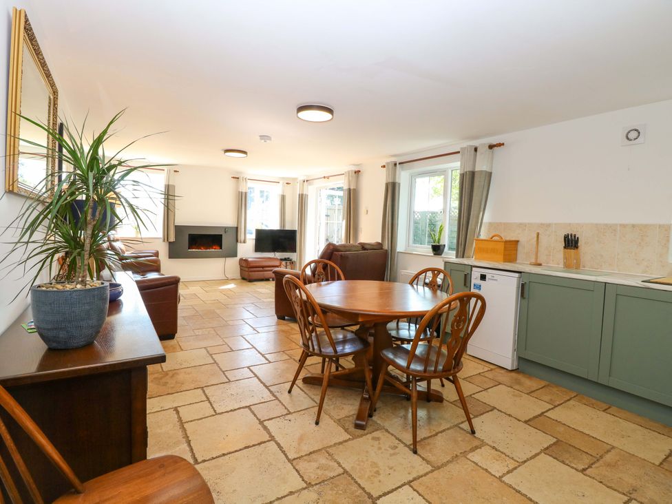 A dining room with a table and chairs at Mill Lodge in Brisley