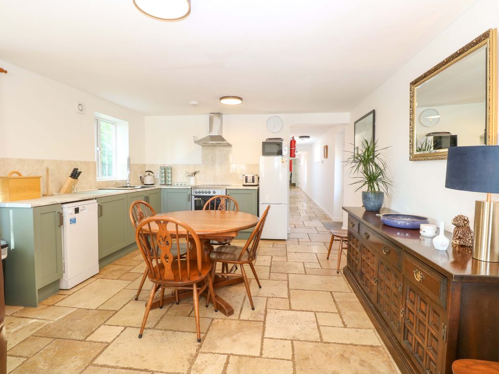 A kitchen with a table and chairs at Mill Lodge in Brisley