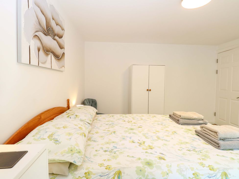 A bedroom with a bed and wardrobe at Mill Lodge in Brisley