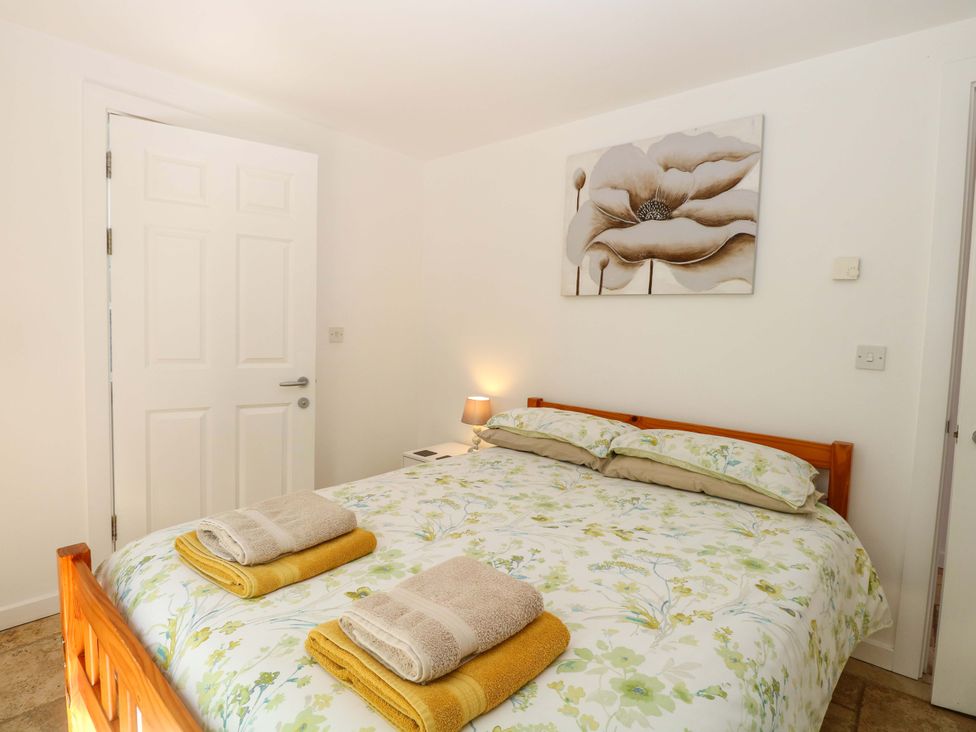 A bedroom with a bed and towels at Mill Lodge in Brisley