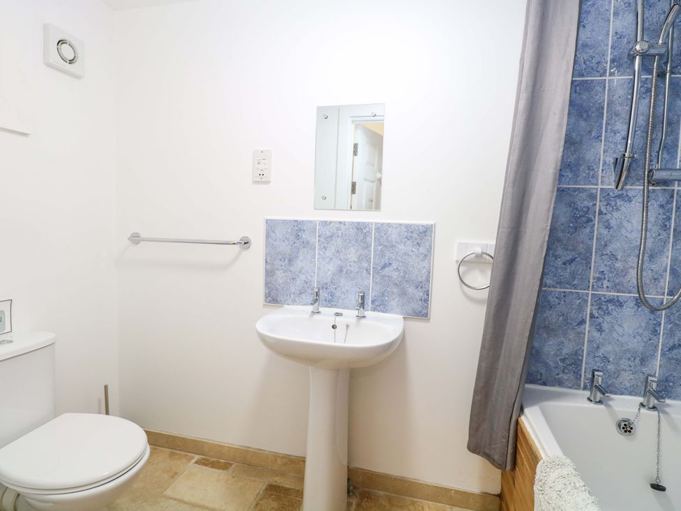 A bathroom with a sink, toilet, and shower at Mill Lodge in Brisley