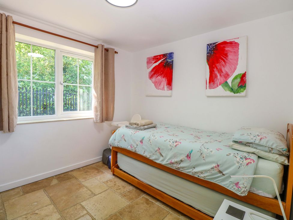 A bedroom with a bed and window at Mill Lodge in Brisley